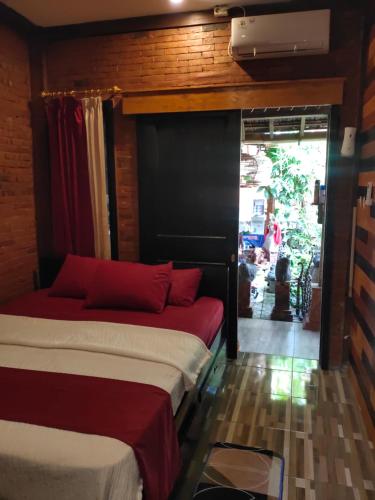 a bedroom with two beds with red pillows at GRHA PAWITRA TROWULAN in Trowulan