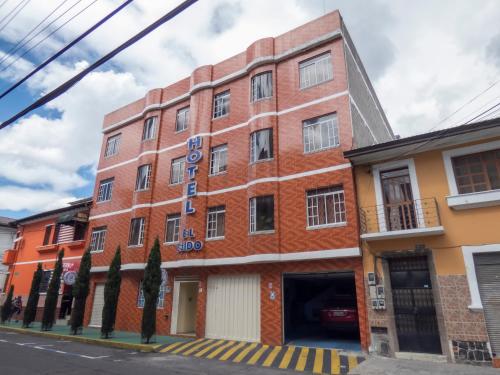 a red brick building on the corner of a street at Hotel El Ejido in Quito