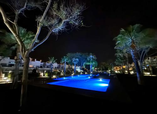 a swimming pool at night with trees and buildings at Condado de Alhama, 2 bed, fully equipped with private roof, Garden 4 in Alhama de Murcia