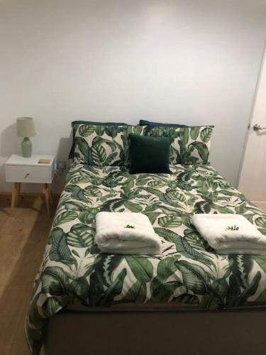 a bed with two pillows on it in a room at Cheerful 3 Bedroom Townhouse in Bangor