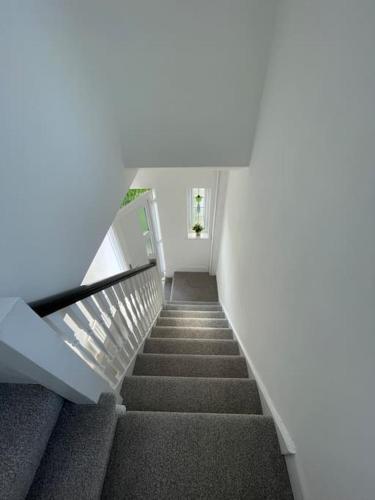a staircase in a building with a stair case at Whole House Modern Two Bedroom in Newcastle - Free Parking in Newcastle upon Tyne