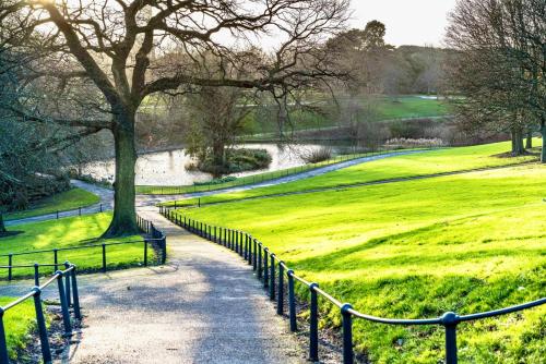 a path through a park with a field of grass at The Garden Luxe Retreat in Dublin