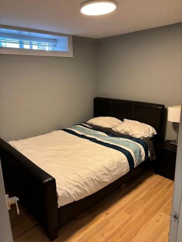 a bedroom with a bed in a room with a window at QE Park Garden suite 3BR 1.5Ba in Vancouver