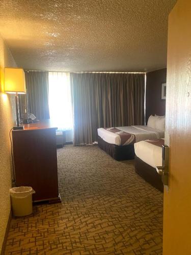 a hotel room with two beds and a desk at Quality Inn View of Lake Powell - Page in Page