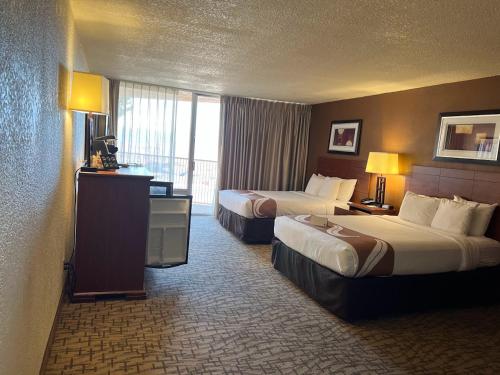 a hotel room with two beds and a balcony at Quality Inn View of Lake Powell - Page in Page