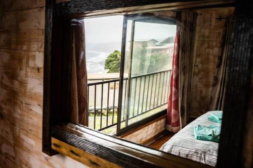 a window in a cabin with a view of a balcony at Quebrada del Mar-Matanzas in Matanzas