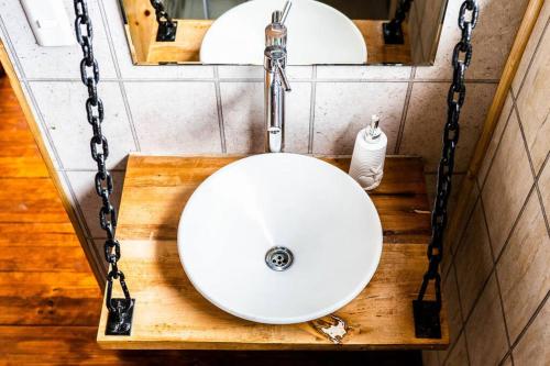 a bathroom with a white sink and two mirrors at Quebrada del Mar-Matanzas in Matanzas