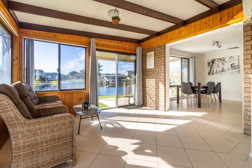 a living room with a view of the water at Duck Inn in Sussex inlet