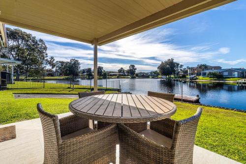 a table and chairs with a view of a lake at Duck Inn in Sussex inlet
