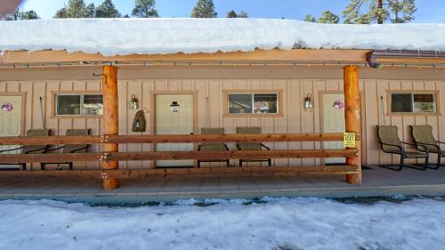 a cabin with a deck in the snow at Arrowhead 11 in Red River