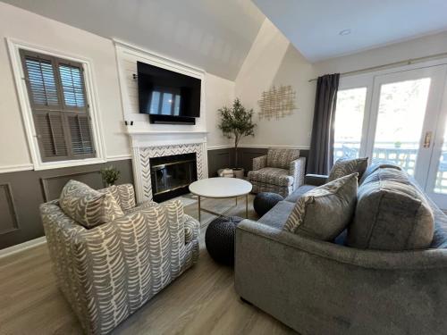 a living room with two couches and a fireplace at Newly Renovated Loft Villa at Norwich Spa with amenities, 3 minutes to Mohegan in Norwich