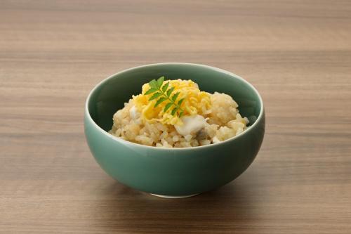 a green bowl of rice with cheese on top at Tokushima Grandvrio Hotel in Tokushima