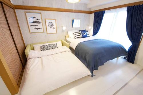 Ένα ή περισσότερα κρεβάτια σε δωμάτιο στο ATAMI Ocean Suite 碧 Ao 301