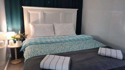 a bed with two pillows on it in a room at Sunset Lounge Guesthouse in Springwood