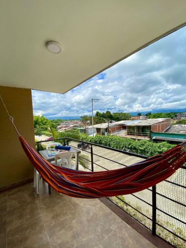 a hammock on the balcony of a house at Apartasol Reserva de la Colina Lindo y Cómodo Apartamento in La Tebaida