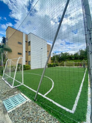 a soccer field with a goal in front of a building at Apartasol Reserva de la Colina Lindo y Cómodo Apartamento in La Tebaida
