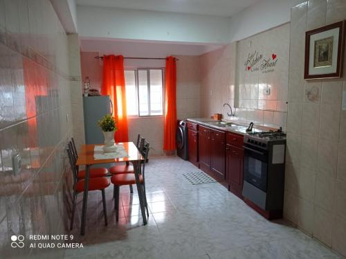 a small kitchen with a table and a stove at Lovely Apartment In Mindelo City Center in Mindelo
