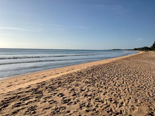 a beach with footprints in the sand and the ocean at Beach Bliss in Trincomalee