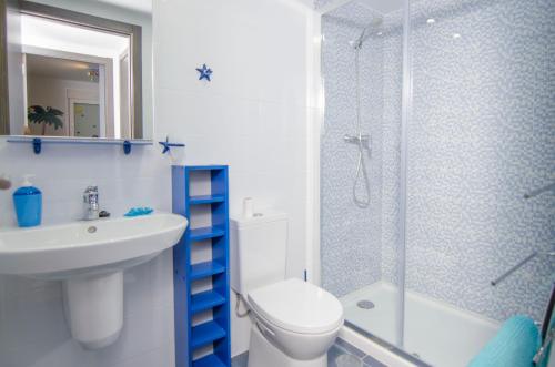 a bathroom with a toilet and a sink and a shower at Novabeach by Mar Holidays in Puerto Marino
