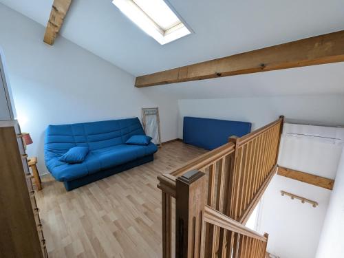 - un salon avec un canapé bleu et des escaliers dans l'établissement Villa T2 Mezzanine Climatisée avec Cour - 6 Pers - Parking - Proche Plage - Meublé Tourisme 1* - FR-1-797-44, à Port-la-Nouvelle