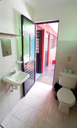 a bathroom with a toilet and a sink at Casa Huipil in San Cristóbal de Las Casas