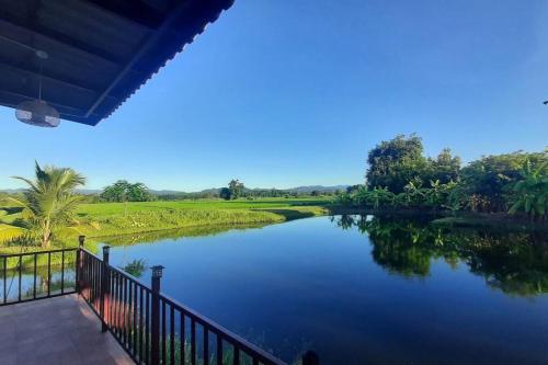 a view of a river from a balcony at Naam and Nork Vegetarian Farmstay in Ban Rong Wua (2)