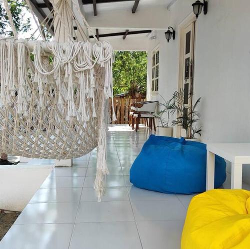 a room with a hammock in a house at Rumah Akbar Villa Taliwang in Labuanbalat