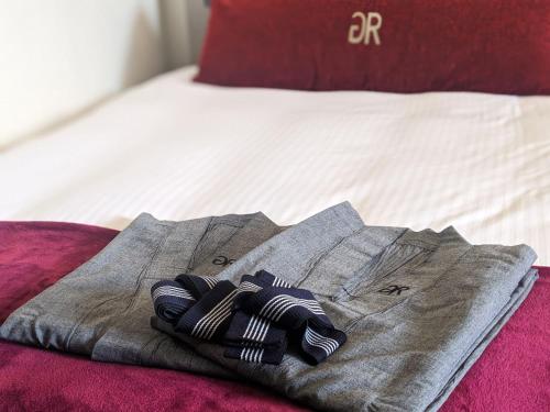 a robe sitting on top of a bed at Green Rich Hotel Nishitetsu Ohashi Ekimae in Fukuoka