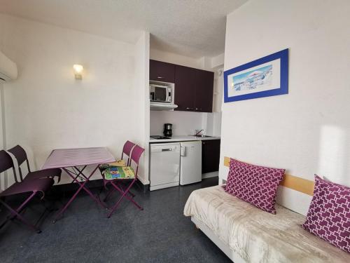 - une petite cuisine avec une table et un canapé dans l'établissement Studio 4 personnes, face plage, parking, climatisation - Le Lavandou - FR-1-803-22, au Lavandou