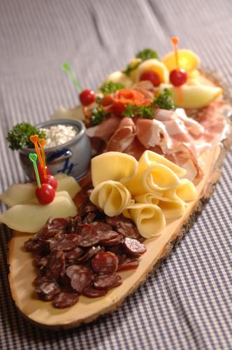 a plate of food with meat and vegetables on a table at Ferienhotel Alber in Mallnitz