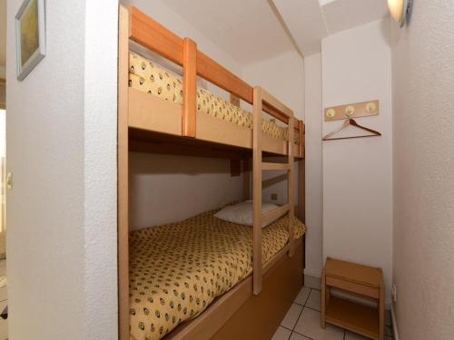 Ce lit superposé se trouve dans une petite chambre. dans l'établissement Studio cabine pour 4 au Lavandou, pieds dans l'eau, clim, WiFi, parking - FR-1-803-5, au Lavandou