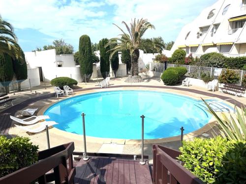 une grande piscine bleue dans une cour dans l'établissement Studio La Grande-Motte 2 pers. - Plage, Piscine, Terrasse, Parking Proche - FR-1-790-29, à La Grande Motte