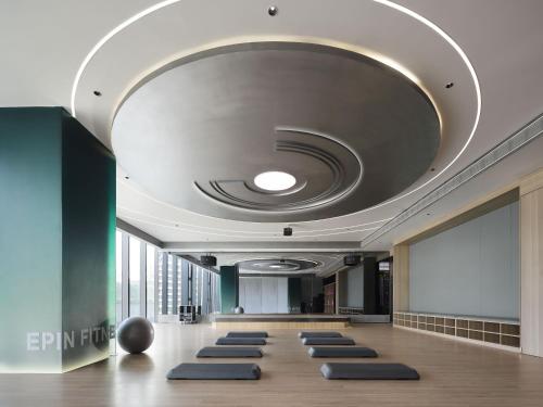 a room with a row of yoga mats on the floor at Grand Mercure Shenzhen Guangming in Shenzhen