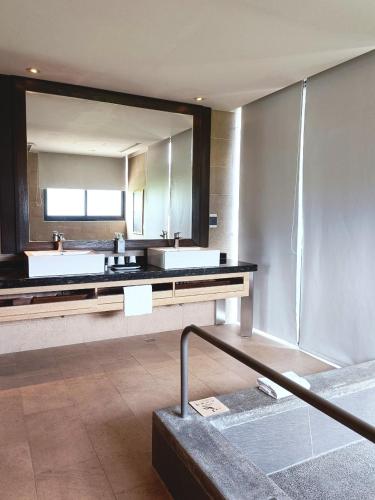 a bathroom with two sinks and a large mirror at Chii Lih Resort in Luye