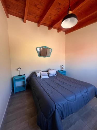 a bedroom with a blue bed with two blue tables at El Descanso del Wayra in Tilcara