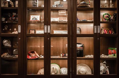 a wooden cabinet filled with lots of items at Hotel Mitru Sur in La Paz