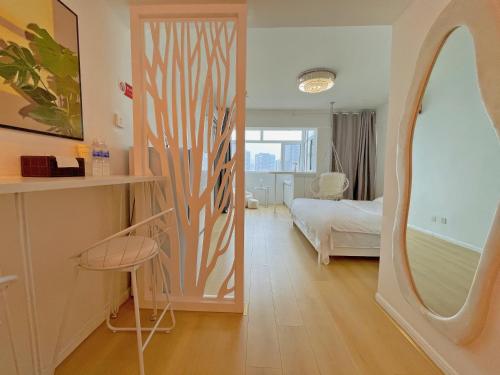 a room with a door to a bedroom with a bed at Mermaid's Secret-Bontique Homestay in Qingdao