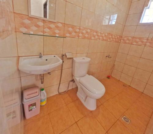 a bathroom with a toilet and a sink at Bahay Ko spacious house in Sariaya Quezon in Sariaya