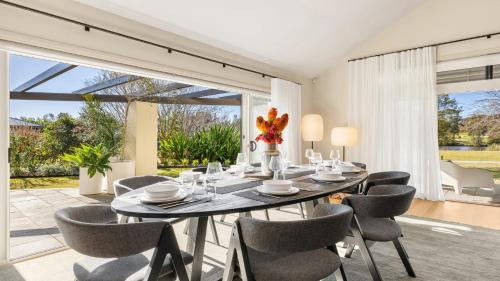 a dining room with a table and chairs at The Lake House - The Vintage in Pokolbin