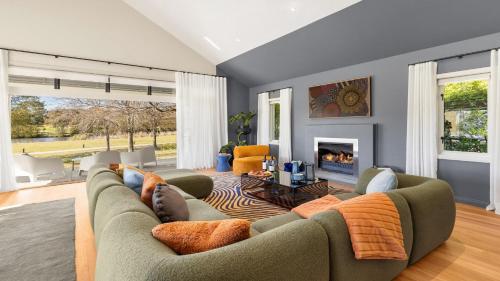 a living room with a couch and a fireplace at The Lake House - The Vintage in Pokolbin