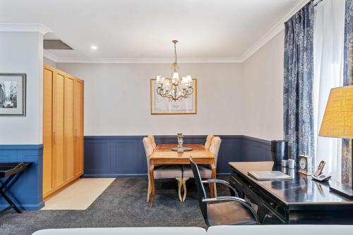 a dining room with a table and a desk at de Russie Boutique Hotel in Orange