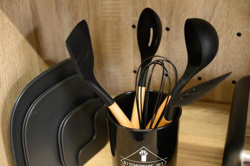 a black container filled with utensils on a table at Crea House in Sapporo