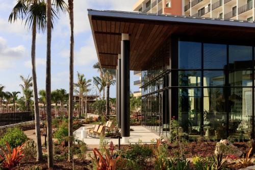 a resort with palm trees and a building at Hotel Indigo Grand Cayman by IHG in Grand Cayman
