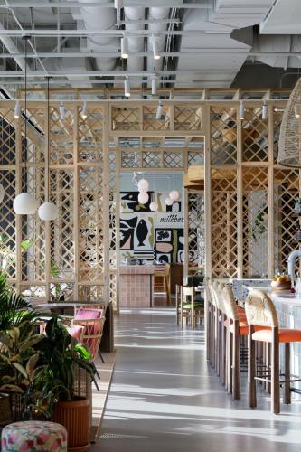 a restaurant with wooden walls and tables and chairs at Hotel Indigo Grand Cayman by IHG in Grand Cayman
