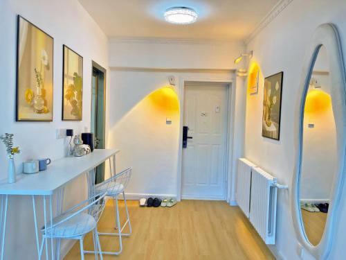 a room with two chairs and a table and a door at Mermaid's Secret-Bontique Homestay in Qingdao