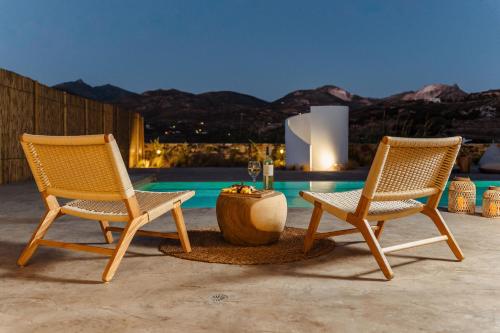 two chairs and a table on a patio at Thalelion 3 bedroom Villas with private pool and Jacuzzi in Naxos Chora
