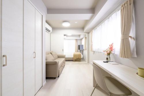 a living room with a couch and a table at Provence Hotel in Tokyo