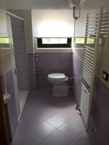 a bathroom with a toilet and a window at B&B Culla Dell'Aquila in LʼAquila