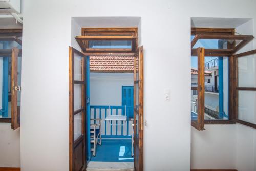 an open door to a room with a balcony at The Bougainvillea in Skopelos Town
