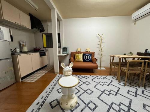 a living room with a kitchen and a room with a table at Golden House in Tokyo